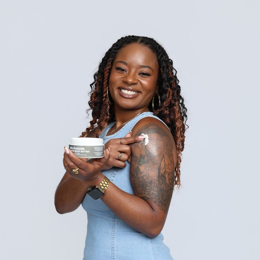 Woman in a blue dress holding a container against a light gray background