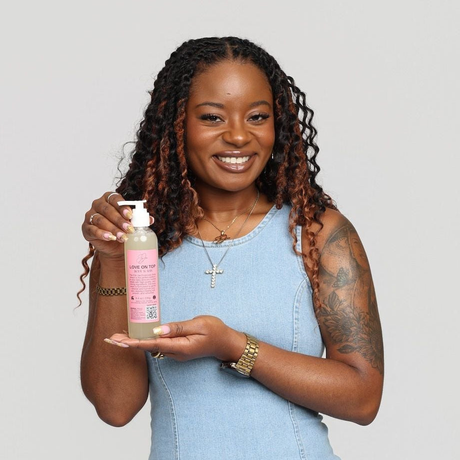 Woman holding a product against a plain background